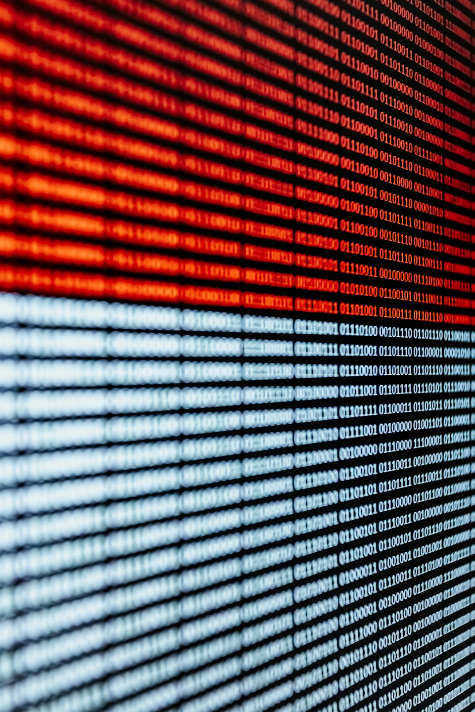 Rows of binary code in red and white diagonal lines.